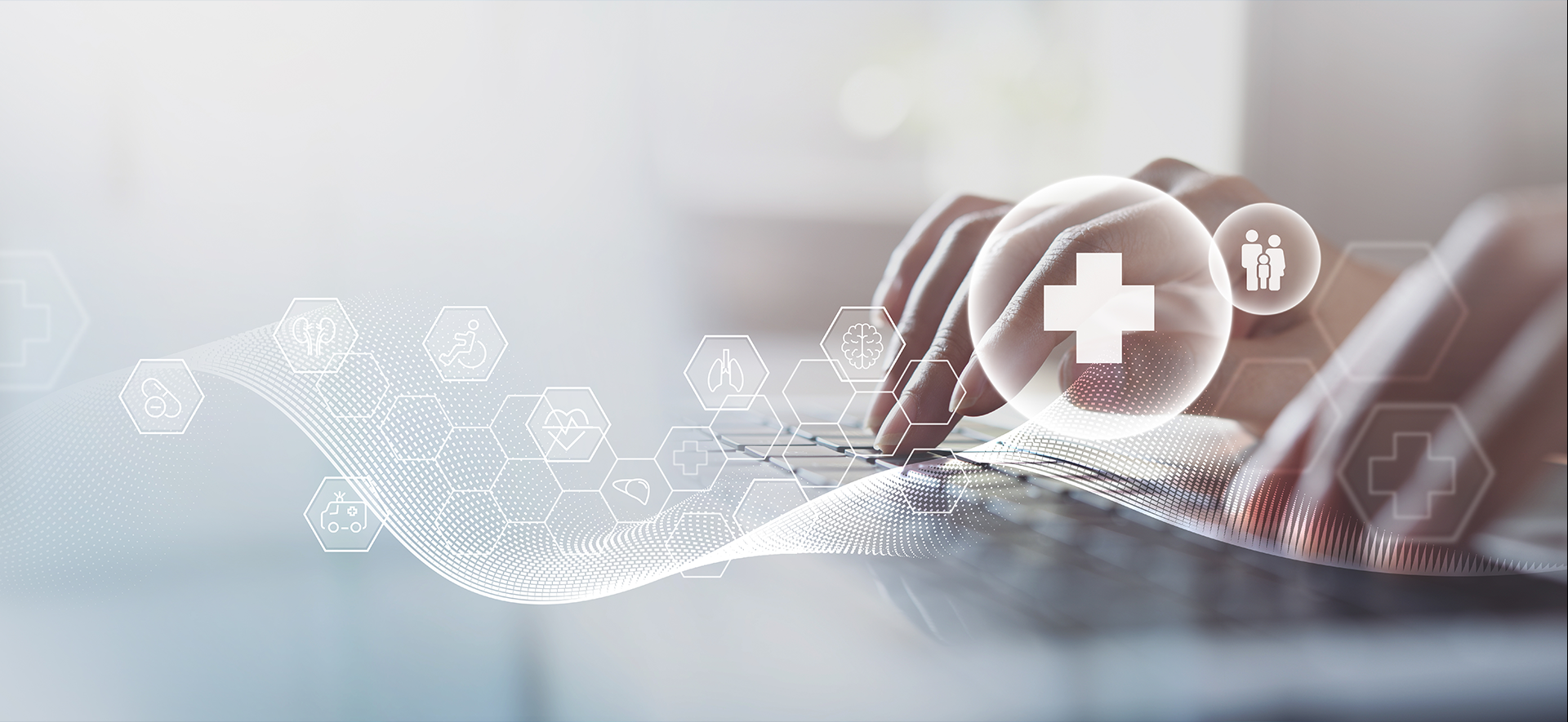 Ikonki związane ze zdrowiem, np. narządy. W tle rozmyte ręce uderzające w klawiaturę