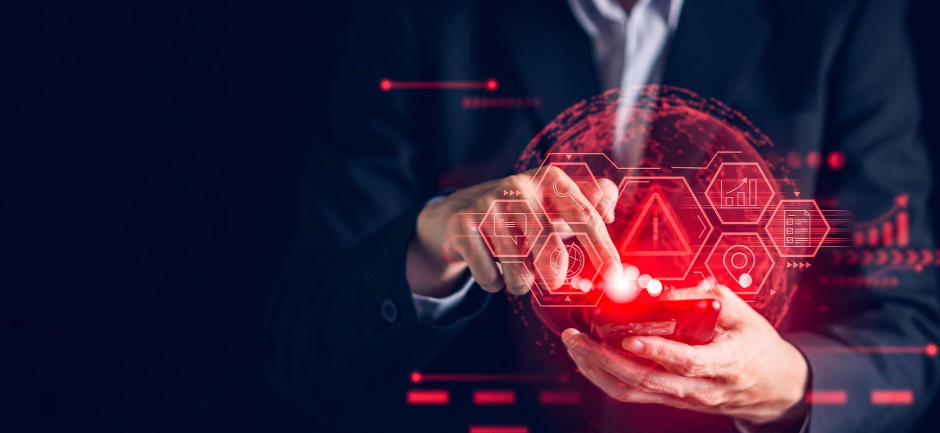 w tle widoczna jest osoba w garniturze, na pierwszym tle widać ręce trzymające telefon , a z niego unszą się czerwone ikony